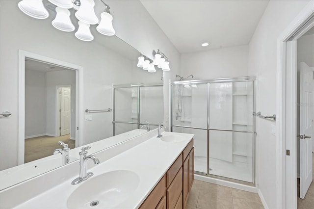 3760 82nd Avenue Cir E Unit 102, Sarasota, FL 34243 - bathroom with a stall shower, double vanity, tile patterned floors, and baseboards