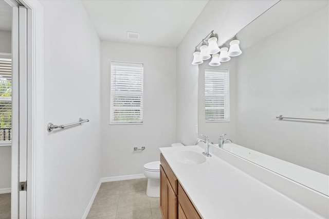 3760 82nd Avenue Cir E Unit 102, Sarasota, FL 34243 - bathroom with toilet, plenty of natural light, vanity, and baseboards