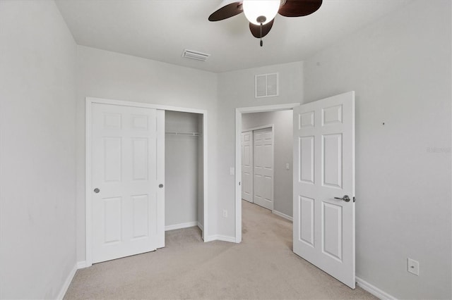 3760 82nd Avenue Cir E Unit 102, Sarasota, FL 34243 - unfurnished bedroom with light carpet, baseboards, a closet, and ceiling fan