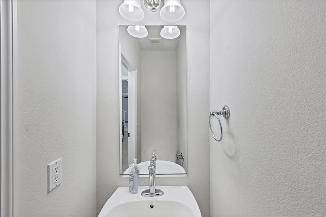 3760 82nd Avenue Cir E Unit 102, Sarasota, FL 34243 - bathroom with a textured wall and a sink