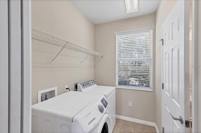 3760 82nd Avenue Cir E Unit 102, Sarasota, FL 34243 - laundry area featuring independent washer and dryer, baseboards, and light tile patterned floors