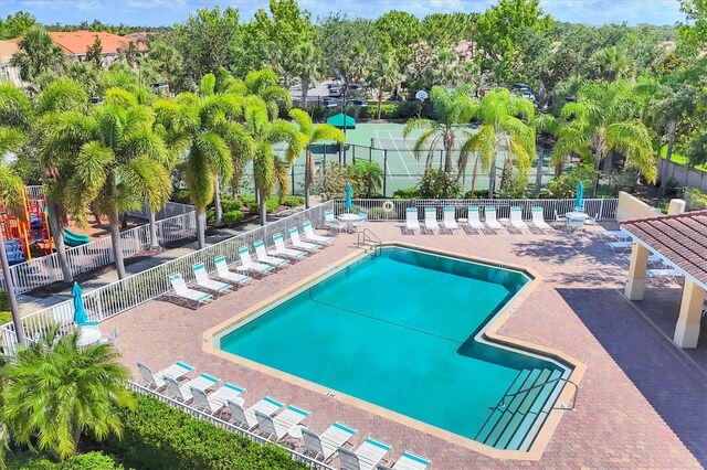 3760 82nd Avenue Cir E Unit 102, Sarasota, FL 34243 - community pool featuring fence, a patio area, and view of scattered trees