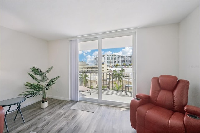 101 S Gulfstream Ave Unit 6C, Sarasota, FL 34236 - living area with wood finished floors, a city view, floor to ceiling windows, and baseboards
