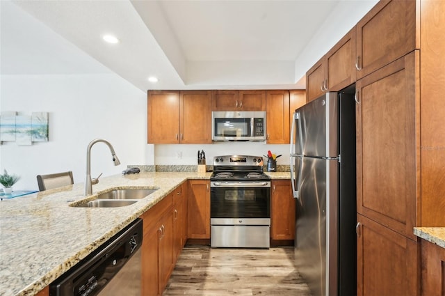 101 S Gulfstream Ave Unit 6C, Sarasota, FL 34236 - kitchen with appliances with stainless steel finishes, a sink, light wood-style floors, light stone counters, and recessed lighting