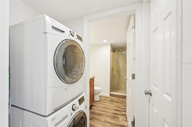 101 S Gulfstream Ave Unit 6C, Sarasota, FL 34236 - laundry area with stacked washer and clothes dryer, light wood-style flooring, and recessed lighting