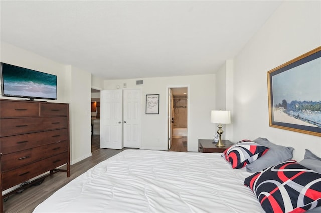 101 S Gulfstream Ave Unit 6C, Sarasota, FL 34236 - bedroom featuring wood finished floors, connected bathroom, and baseboards