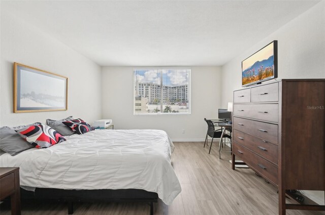 101 S Gulfstream Ave Unit 6C, Sarasota, FL 34236 - bedroom with light wood finished floors, baseboards, and an office area