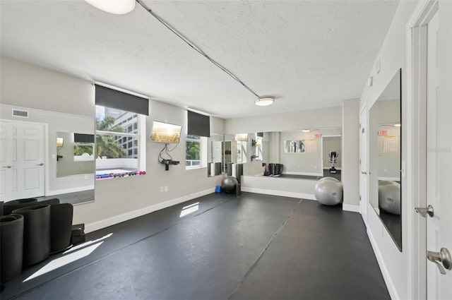 101 S Gulfstream Ave Unit 6C, Sarasota, FL 34236 - exercise room featuring a textured ceiling and baseboards