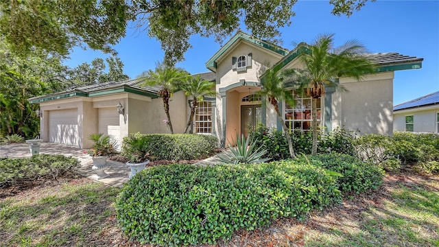 4920 Woodhurst Dr, Sarasota, FL 34243 - mediterranean / spanish-style home featuring stucco siding, an attached garage, and driveway