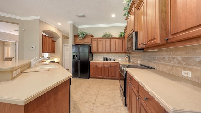 4920 Woodhurst Dr, Sarasota, FL 34243 - kitchen featuring stainless steel appliances, a sink, brown cabinetry, backsplash, and light countertops