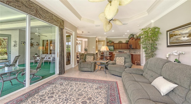 4920 Woodhurst Dr, Sarasota, FL 34243 - living room with a ceiling fan, plenty of natural light, crown molding, light tile patterned floors, and a raised ceiling
