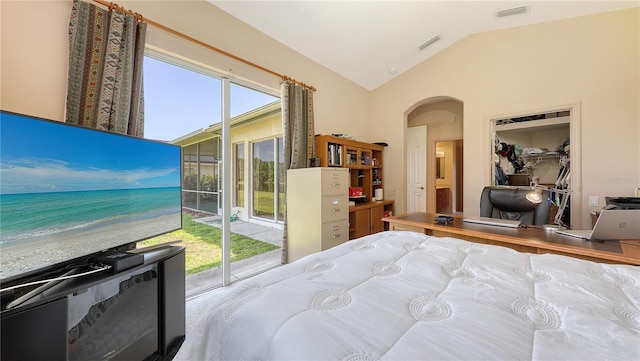 4920 Woodhurst Dr, Sarasota, FL 34243 - bedroom featuring lofted ceiling, arched walkways, and access to exterior
