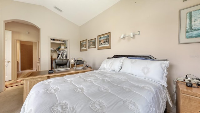 4920 Woodhurst Dr, Sarasota, FL 34243 - carpeted bedroom featuring lofted ceiling, arched walkways, and a closet