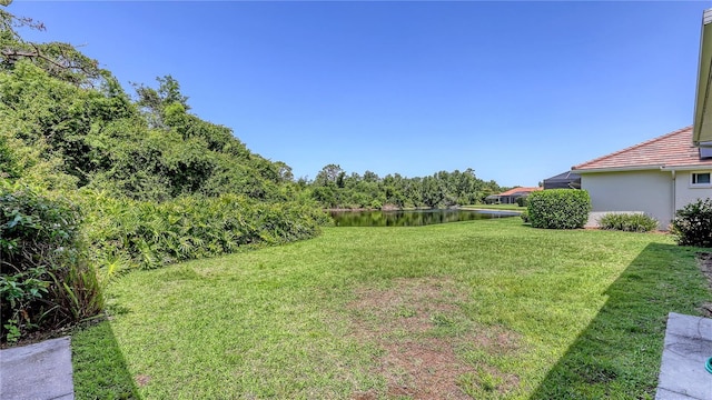 4920 Woodhurst Dr, Sarasota, FL 34243 - view of green lawn featuring a water view