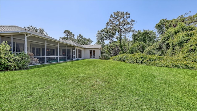4920 Woodhurst Dr, Sarasota, FL 34243 - view of grassy yard with a sunroom