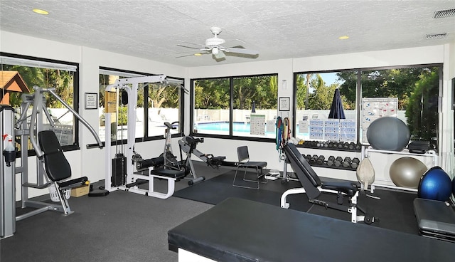 4920 Woodhurst Dr, Sarasota, FL 34243 - exercise room featuring a ceiling fan and a textured ceiling