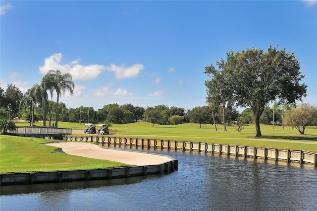 4920 Woodhurst Dr, Sarasota, FL 34243 - view of community featuring golf course view, a yard, a water view, and view of scattered trees