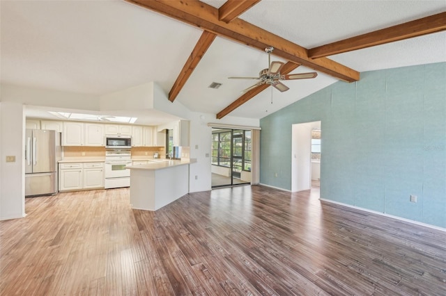104 Hourglass Dr, Venice, FL 34293 - unfurnished living room featuring light wood finished floors, ceiling fan, and a skylight