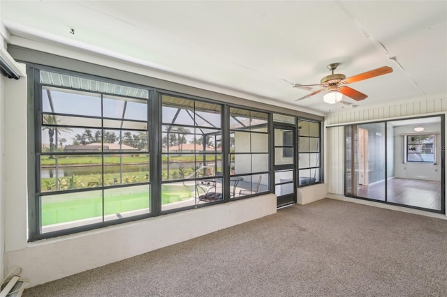 104 Hourglass Dr, Venice, FL 34293 - unfurnished sunroom with a ceiling fan, carpet floors, and a water view