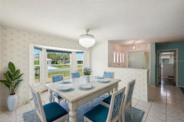 104 Hourglass Dr, Venice, FL 34293 - dining area with light tile patterned flooring and wallpapered walls