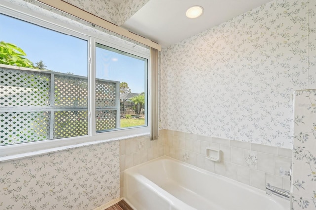 104 Hourglass Dr, Venice, FL 34293 - bathroom featuring wallpapered walls and a garden tub