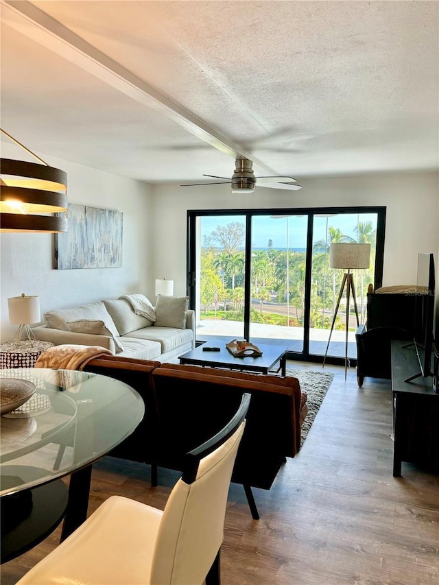 5855 Midnight Pass Rd Unit 621, Sarasota, FL 34242 - living area with healthy amount of natural light, a textured ceiling, a ceiling fan, and wood finished floors