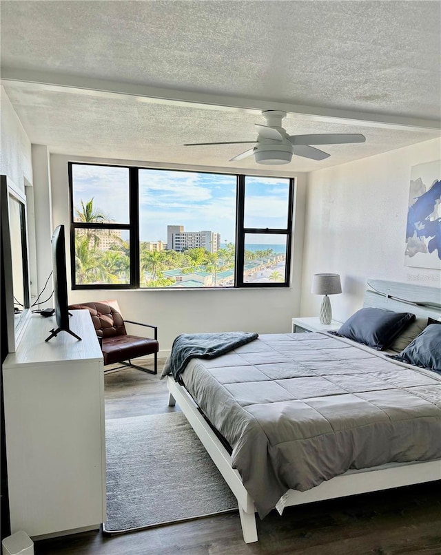 5855 Midnight Pass Rd Unit 621, Sarasota, FL 34242 - bedroom featuring wood finished floors, a textured ceiling, and ceiling fan