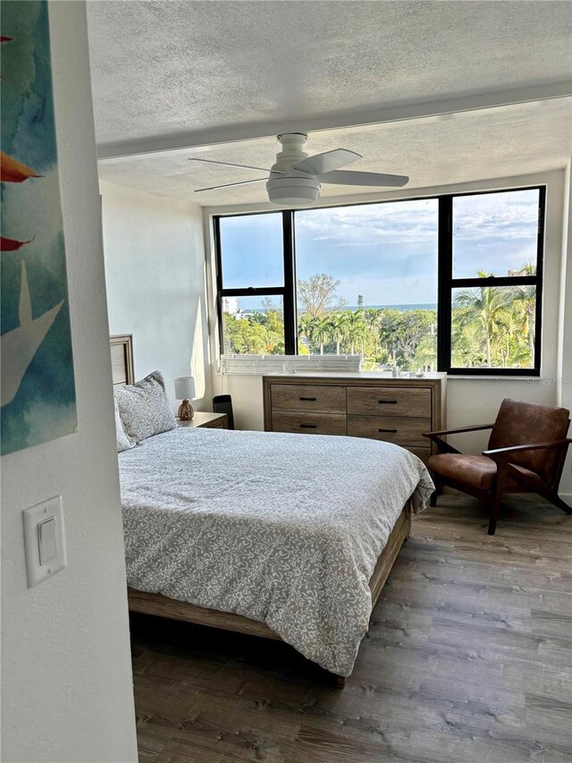 5855 Midnight Pass Rd Unit 621, Sarasota, FL 34242 - bedroom with hardwood / wood-style floors and a textured ceiling