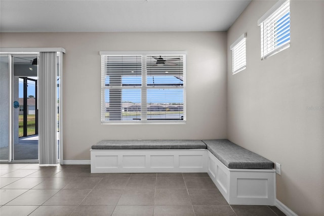 unfurnished room featuring baseboards and tile patterned floors