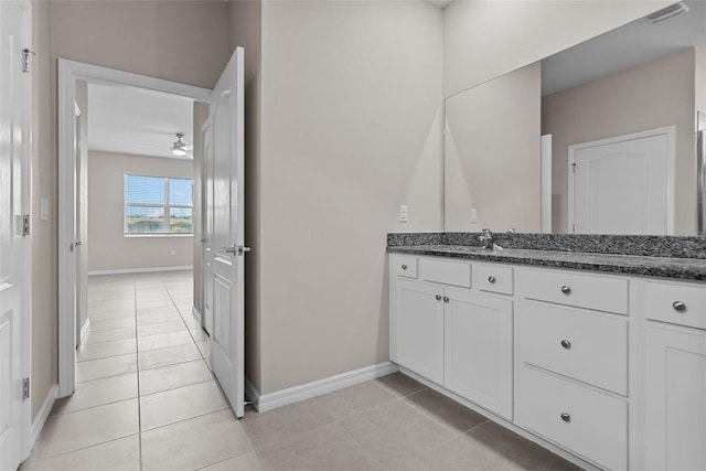 bathroom with a ceiling fan, baseboards, tile patterned floors, and vanity