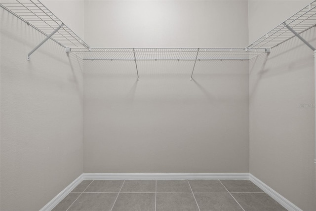 spacious closet featuring tile patterned flooring