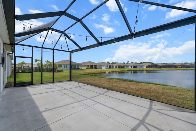 unfurnished sunroom with a water view and a residential view