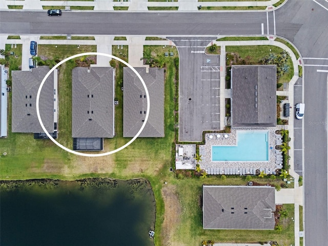 aerial view of a pool and a nearby body of water