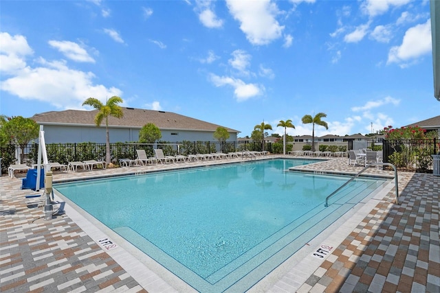 community pool featuring fence and a patio
