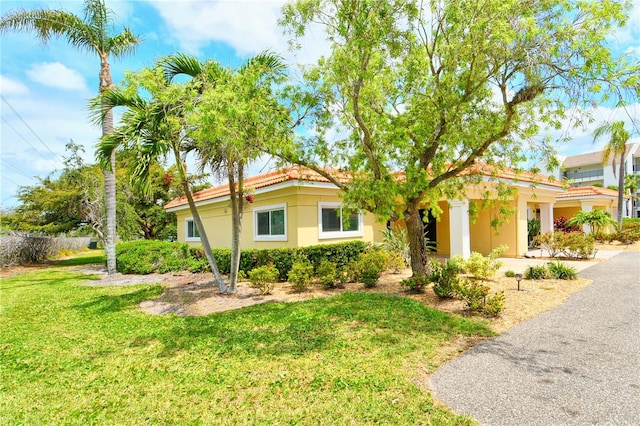 4840 Gulf Of Mexico Dr Unit 15, Longboat Key, FL 34228 - view of front of home with a front yard, stucco siding, and a tiled roof