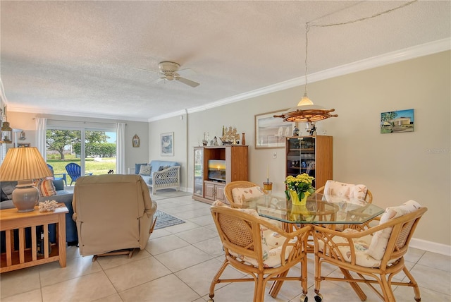 4840 Gulf Of Mexico Dr Unit 15, Longboat Key, FL 34228 - dining room featuring ornamental molding, a textured ceiling, light tile patterned floors, ceiling fan, and baseboards