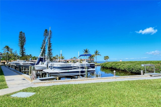 4840 Gulf Of Mexico Dr Unit 15, Longboat Key, FL 34228 - dock area featuring boat lift, a water view, and a yard