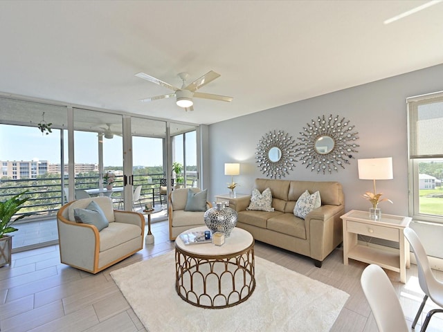 4550 Pinebrook Cir Unit 608, Bradenton, FL 34209 - living room with ceiling fan and expansive windows