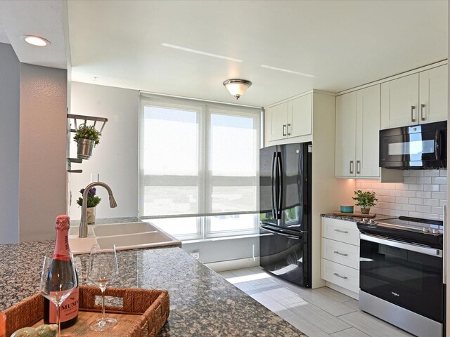 4550 Pinebrook Cir Unit 608, Bradenton, FL 34209 - kitchen with black appliances, a sink, tasteful backsplash, white cabinets, and recessed lighting
