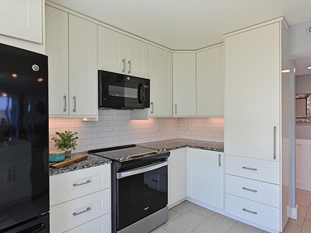 4550 Pinebrook Cir Unit 608, Bradenton, FL 34209 - kitchen with black appliances, dark stone countertops, white cabinetry, and tasteful backsplash