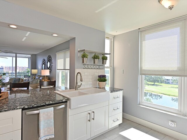 4550 Pinebrook Cir Unit 608, Bradenton, FL 34209 - kitchen with dishwasher, a sink, dark stone countertops, white cabinetry, and recessed lighting