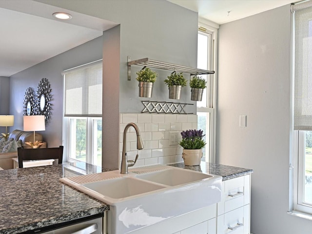 4550 Pinebrook Cir Unit 608, Bradenton, FL 34209 - kitchen with a sink, healthy amount of natural light, white cabinetry, and decorative backsplash