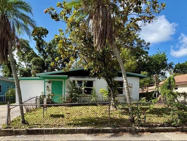 1758 35th St, Sarasota, FL 34234 - view of front of home featuring concrete driveway, a fenced front yard, and stucco siding