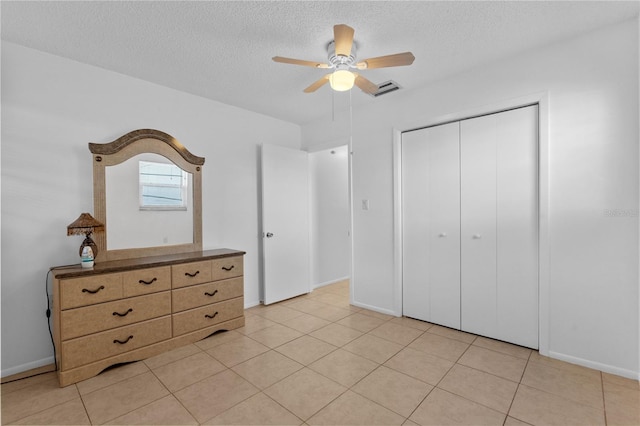 505 47th Avenue Dr W, Bradenton, FL 34207 - bedroom featuring a textured ceiling, a closet, a ceiling fan, light tile patterned floors, and baseboards