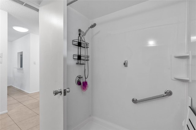 505 47th Avenue Dr W, Bradenton, FL 34207 - bathroom with tile patterned flooring, a shower, and baseboards