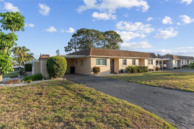 505 47th Avenue Dr W, Bradenton, FL 34207 - ranch-style house featuring asphalt driveway, a carport, and a front lawn