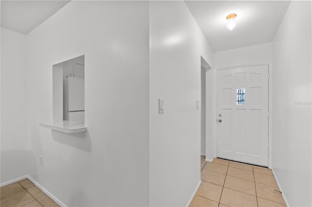 505 47th Avenue Dr W, Bradenton, FL 34207 - foyer entrance with light tile patterned floors, a textured ceiling, and baseboards