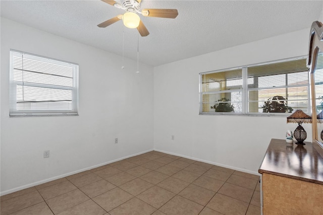 505 47th Avenue Dr W, Bradenton, FL 34207 - spare room with a ceiling fan, light tile patterned floors, a textured ceiling, and baseboards