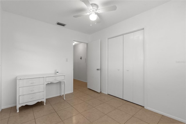 505 47th Avenue Dr W, Bradenton, FL 34207 - unfurnished bedroom with a closet, light tile patterned floors, baseboards, and ceiling fan
