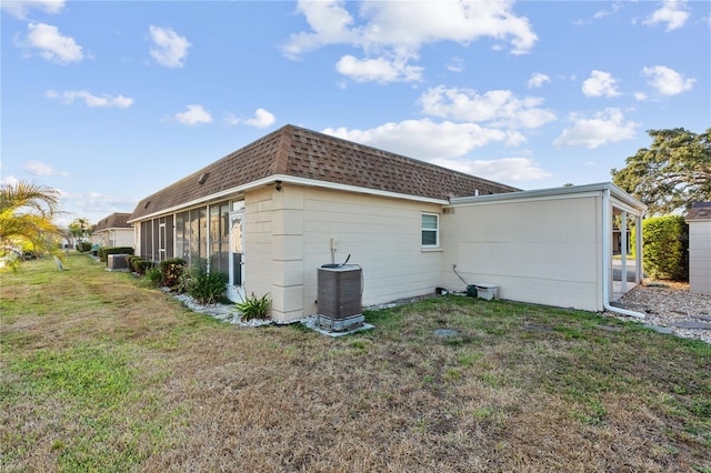 505 47th Avenue Dr W, Bradenton, FL 34207 - back of property with a yard, central air condition unit, roof with shingles, and concrete block siding
